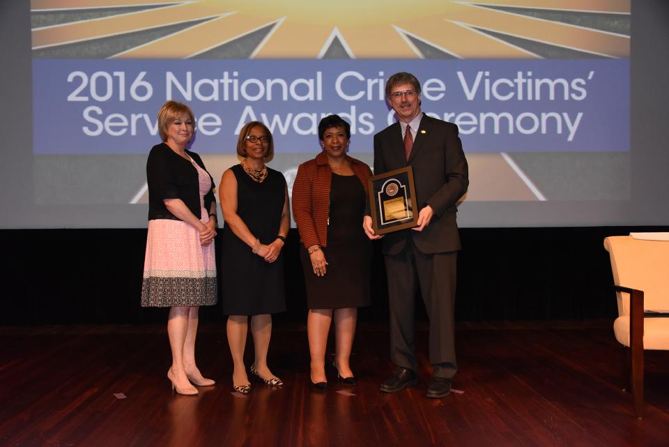 2016 Crime Victims’ Rights Award recipient Russell P. Butler with (from left) Joye E. Frost, Director, Office for Victims of Crime; Karol V. Mason, Assistant Attorney General; and Attorney General Loretta E. Lynch.
