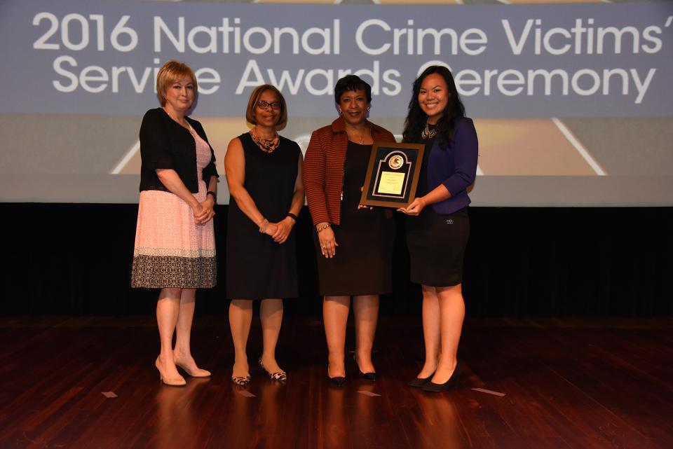 2016 Tomorrow’s Leaders Award recipient Miki Nishizawa with (from left) Joye E. Frost, Director, Office for Victims of Crime; Karol V. Mason, Assistant Attorney General; and Attorney General Loretta E. Lynch.