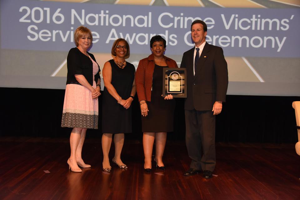 2016 Crime Victims Financial Restoration Award recipient Stephen J. Pfleger with (from left) Joye E. Frost, Director, Office for Victims of Crime; Karol V. Mason, Assistant Attorney General; and Attorney General Loretta E. Lynch.