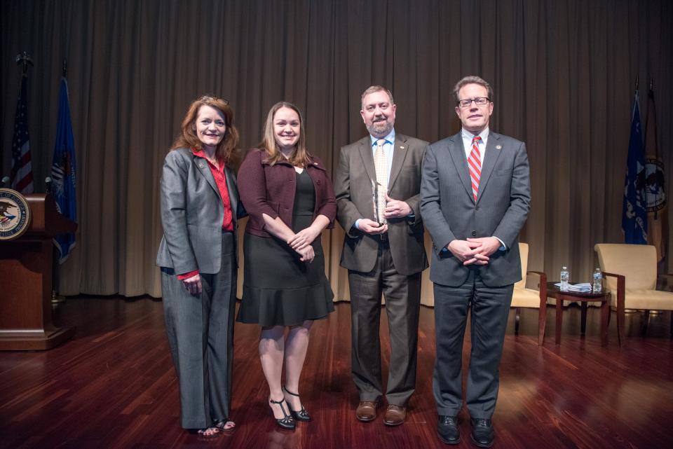 The Victim Services Unit Volunteers, Travis County Sheriff's Office, receive the 2018 Volunteer for Victims Award. Pictured from left: OVC Director Darlene Hutchinson, Heather Dooley, David Holmes, and Principal Deputy Assistant Attorney General for the Office of Justice Programs Alan Hanson.