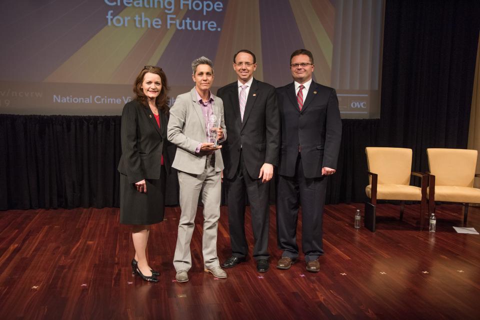 Sergeant Amy Dudewicz receives the 2019 Allied Professional Award with (from left) OVC Director Darlene Hutchinson, Deputy Attorney General Rod J. Rosenstein, and Principal Deputy Assistant Attorney General for the Office of Justice Programs Matt M. Dummermuth.