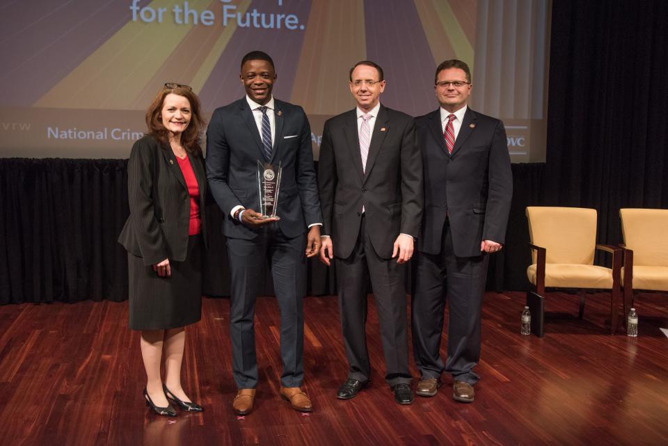 James Shaw, Jr. receives the 2019 Special Courage Award with (from left) OVC Director Darlene Hutchinson, Deputy Attorney General Rod J. Rosenstein, and Principal Deputy Assistant Attorney General for the Office of Justice Programs Matt M. Dummermuth.