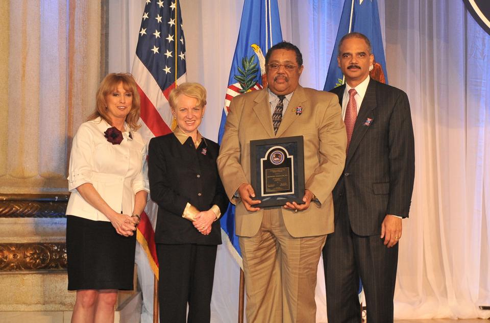Award recipient Kenneth Barnes, with (from left) Joye E. Frost, Acting Director, Office for Victims of Crime; Laurie O. Robinson, Acting Assistant Attorney General, Office of Justice Programs; and U.S. Attorney General Eric H. Holder, Jr.