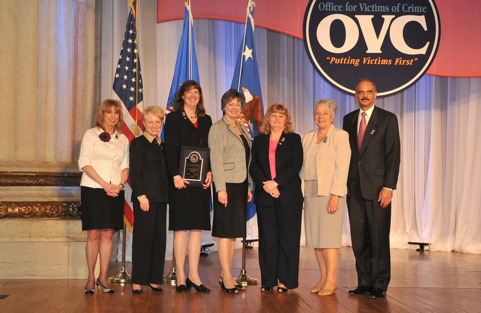 The Financial Litigation Unit of the U.S. Attorney's Office for the Eastern District of North Carolina receives an award from (left) Joye E. Frost, Acting Director, Office for Victims of Crime; Laurie O. Robinson, Acting Assistant Attorney General, Office of Justice Programs; and U.S. Attorney General Eric H. Holder, Jr.