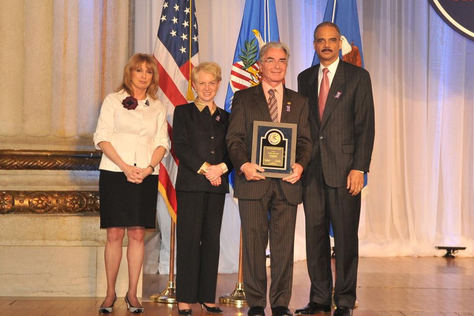 Award recipient Dr. Daniel Man, with (from left) Joye E. Frost, Acting Director, Office for Victims of Crime; Laurie O. Robinson, Acting Assistant Attorney General, Office of Justice Programs; and U.S. Attorney General Eric H. Holder, Jr.
