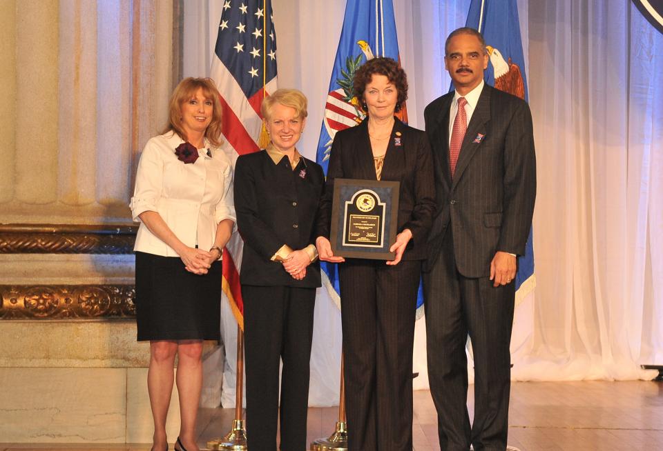 Award recipient Barbara Skudlarick, with (from left) Joye E. Frost, Acting Director, Office for Victims of Crime; Laurie O. Robinson, Acting Assistant Attorney General, Office of Justice Programs; and U.S. Attorney General Eric H. Holder, Jr.