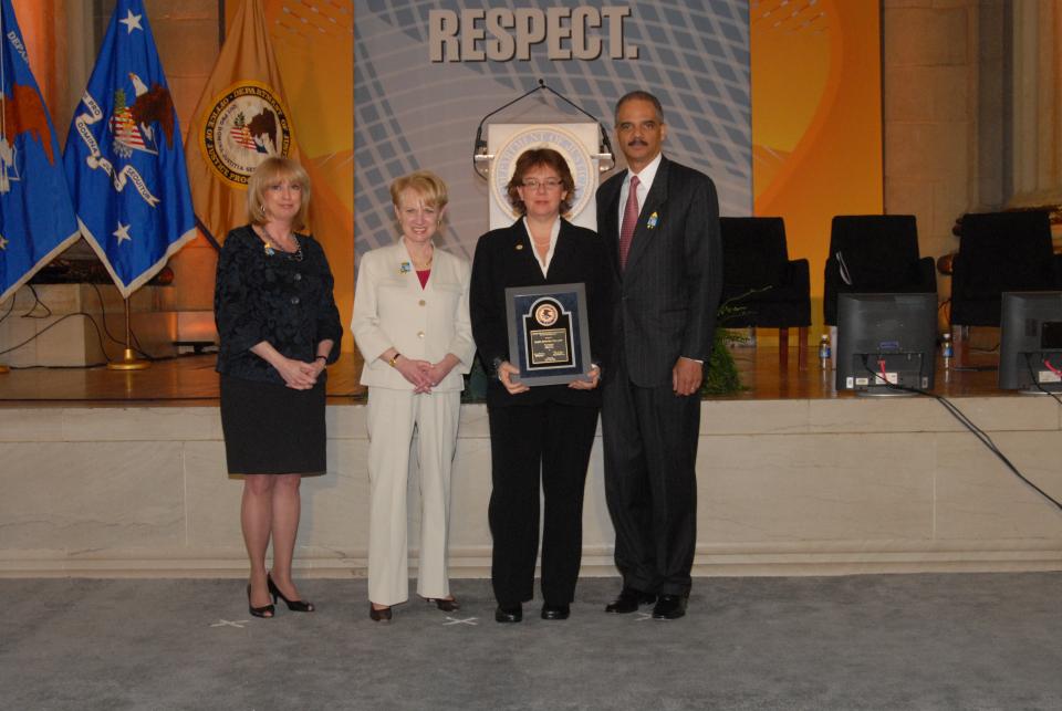 Barri Rosenbluth, recipient of the 2010 Award for Professional Innovation in Victim Services, with (from left) Joye E. Frost, Acting Director, Office for Victims of Crime; Assistant Attorney General Laurie O. Robinson, Office of Justice Programs; and U.S. Attorney General Eric H. Holder, Jr.
