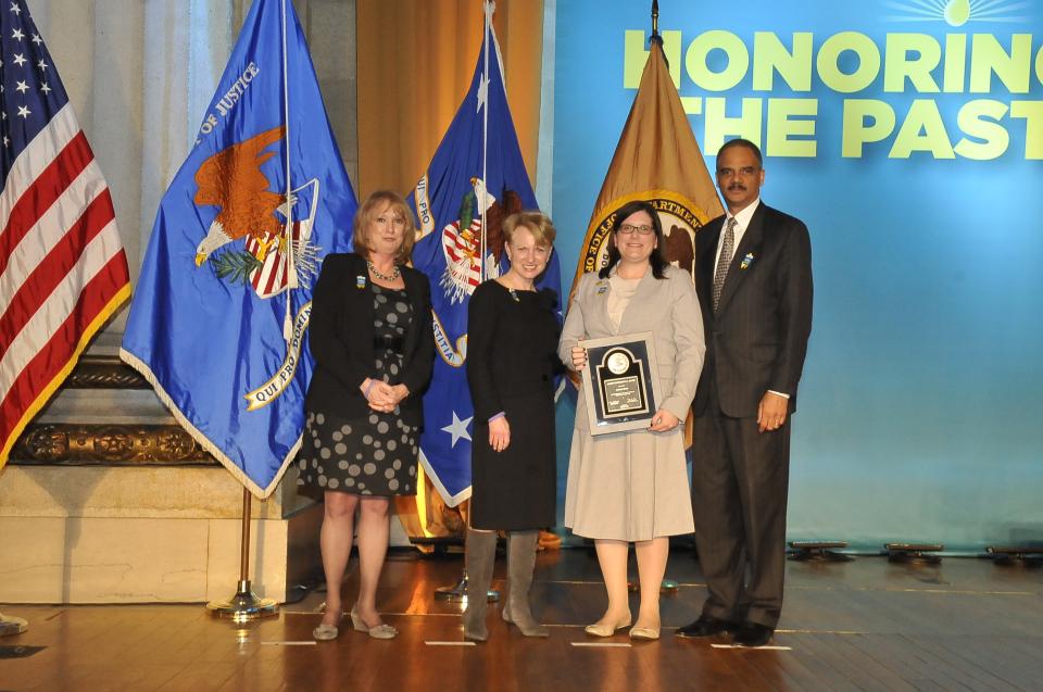 2011 Allied Professional Award recipient Sarah Deer stands with (from left) Joye E. Frost, Acting Director, Office for Victims of Crime; Assistant Attorney General Laurie O. Robinson, Office of Justice Programs; and U.S. Attorney General Eric H. Holder, Jr.