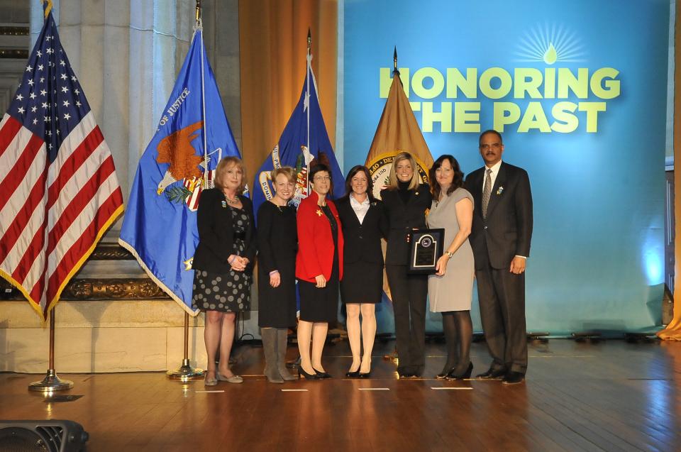 Accepting the 2011 Award for Professional Innovation in Victim Services for the Elder Abuse Forensic Center are (from left) Laura Mosqueda, M.D.; Cherie Hill; Kerry Burnight, Ph.D.; and Gerlyn Bowman, with Joye E. Frost, Acting Director, Office for Victims of Crime; Assistant Attorney General Laurie O. Robinson, Office of Justice Programs; and U.S. Attorney General Eric H. Holder, Jr.