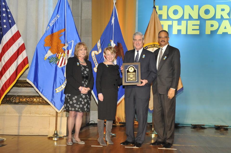 2011 Federal Service Award recipient Robert S. Mueller, III, Director, Federal Bureau of Investigation, stands with (from left) Joye E. Frost, Acting Director, Office for Victims of Crime; Assistant Attorney General Laurie O. Robinson, Office of Justice Programs; and U.S. Attorney General Eric H. Holder, Jr.