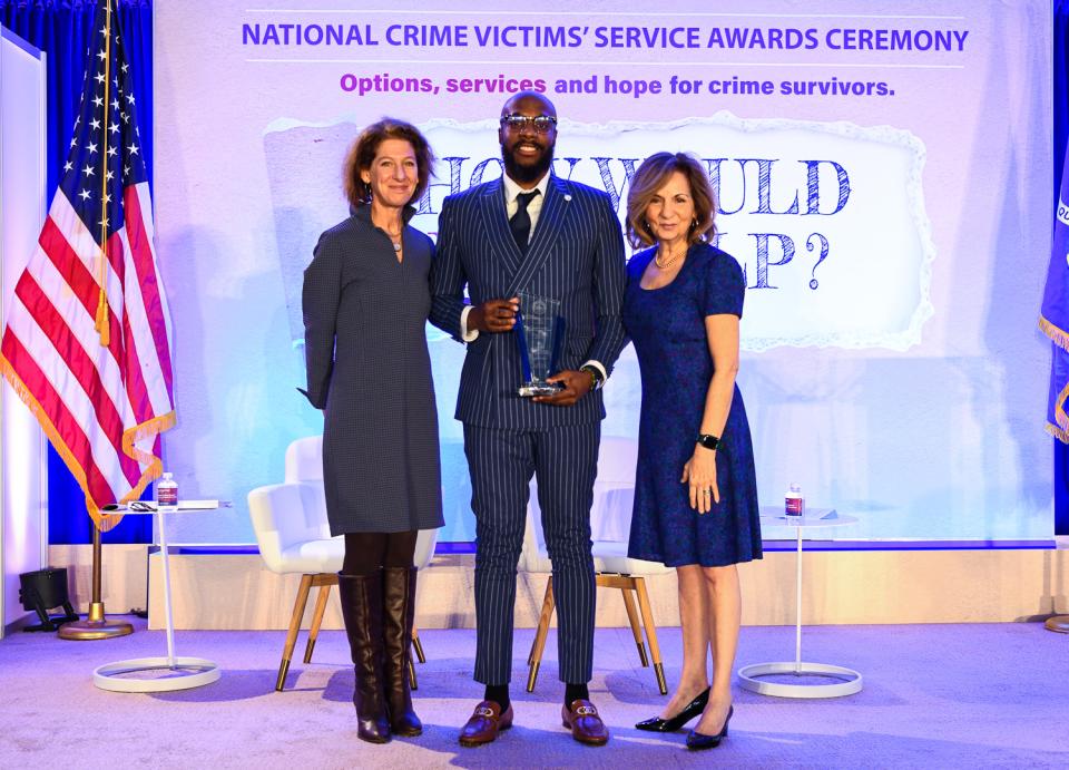 Aswad Thomas, MSW receives the 2024 Survivor Voices Award with (from left) OVC Director Kristina Rose and Assistant Attorney General Amy L. Solomon.