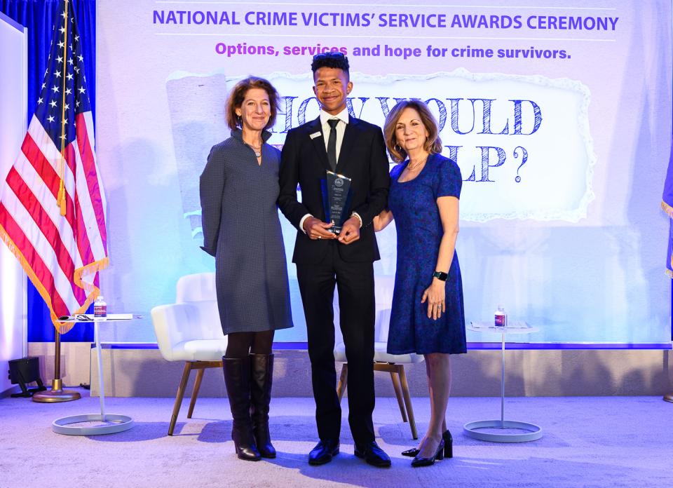 Elijah Lee receives the 2024 Tomorrow’s Leader Award with (from left) OVC Director Kristina Rose and Assistant Attorney General Amy L. Solomon.