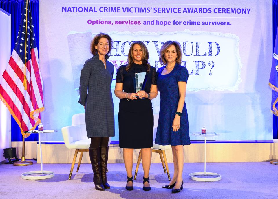 Michelle S. Ballan, Ph.D., MSW receives the 2024 Building Knowledge Through Research Award with (from left) OVC Director Kristina Rose and Assistant Attorney General Amy L. Solomon.