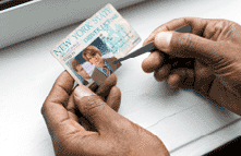 Photo of someone illegally replacing the photo in a New York State driver�s license.