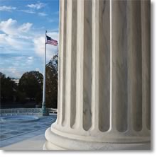 Photo of the U.S. flag next to a white pillar