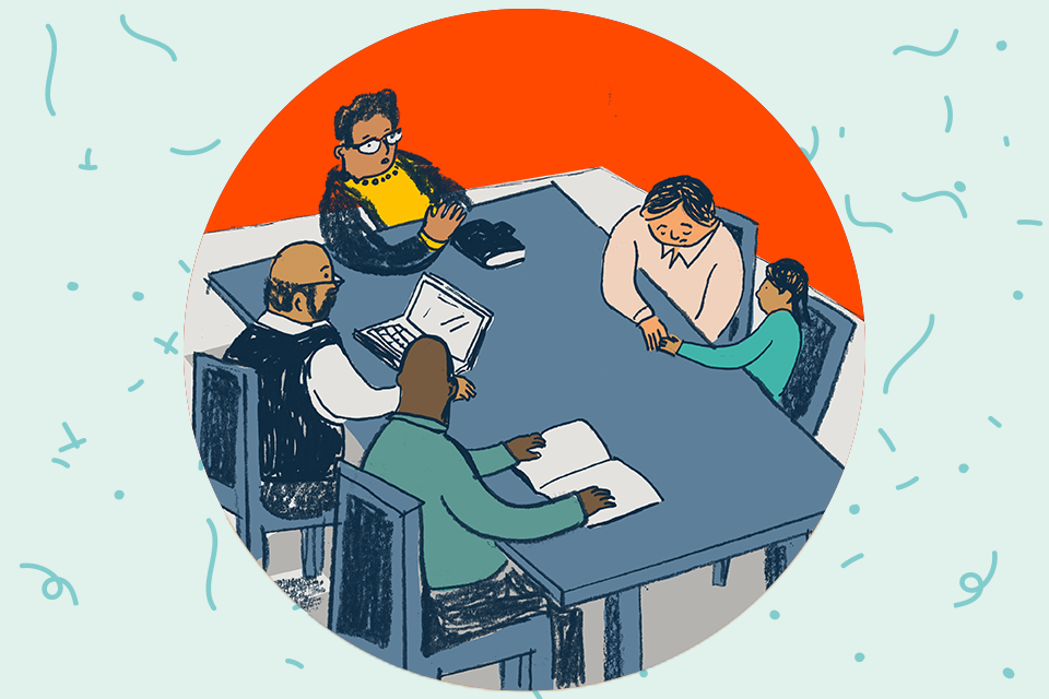 Four adults at a table comforting a child
