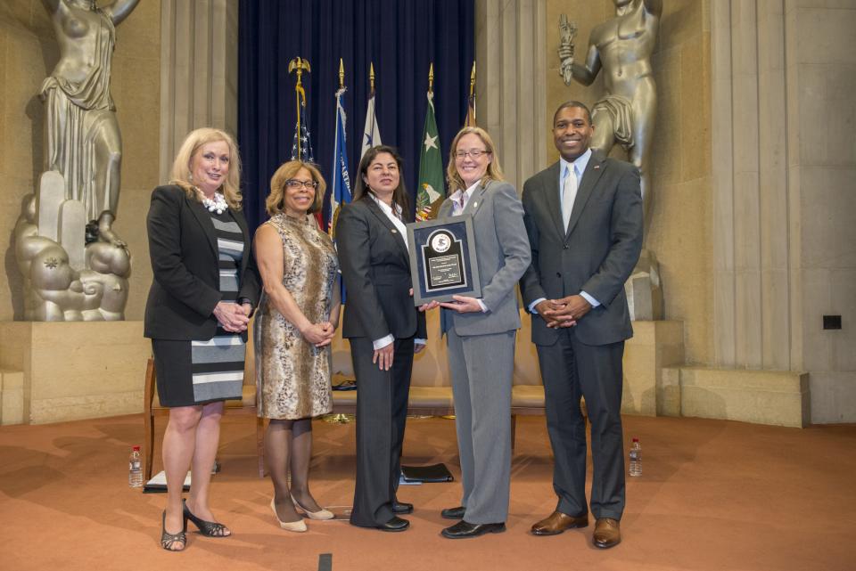 Margaret Aceves and Julie Marie Renfroe accept the 2014 Award for Professional Innovation in Victim Services for the Rapid DNA Service Team, with Joye E. Frost, Director, Office for Victims of Crime; Karol V. Mason, Assistant Attorney General, Office of Justice Programs; and Associate Attorney General Tony West.